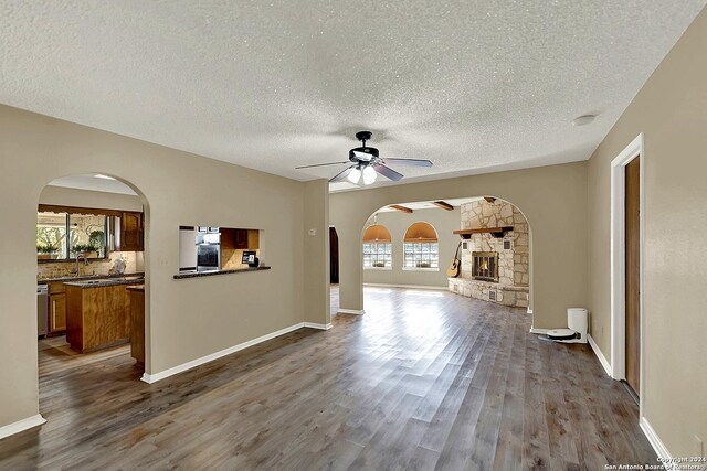 6776 Green Valley Rd, Cibolo, TX 78108 - kitchen with arched walkways, appliances with stainless steel finishes, tasteful backsplash, and a textured ceiling