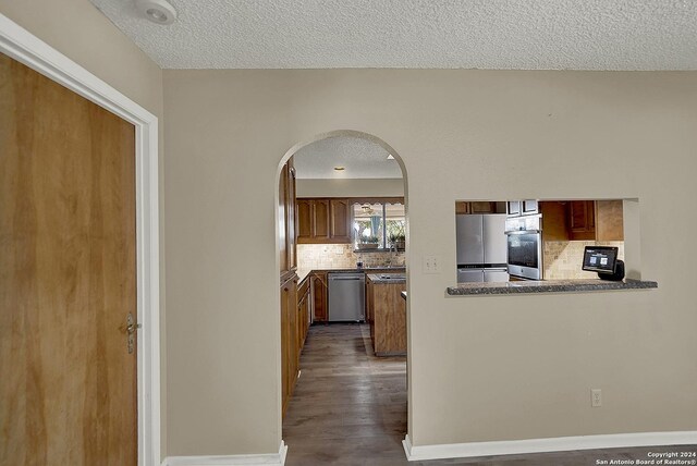 6776 Green Valley Rd, Cibolo, TX 78108 - empty room with wood finished floors, a textured ceiling, a ceiling fan, and french doors