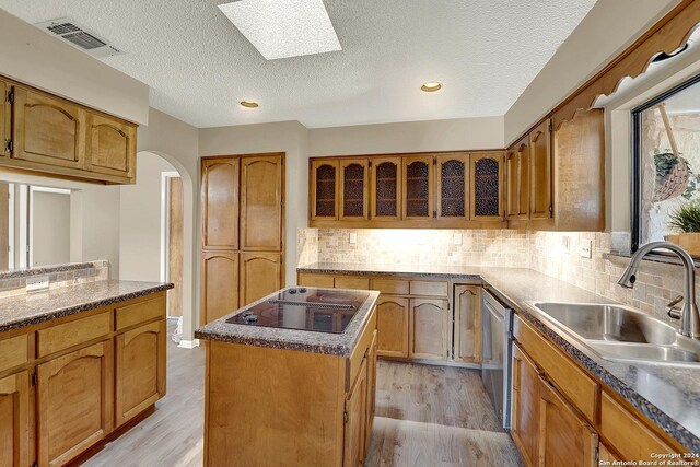 6776 Green Valley Rd, Cibolo, TX 78108 - kitchen with a sink, tasteful backsplash, light wood-type flooring, brown cabinets, and appliances with stainless steel finishes