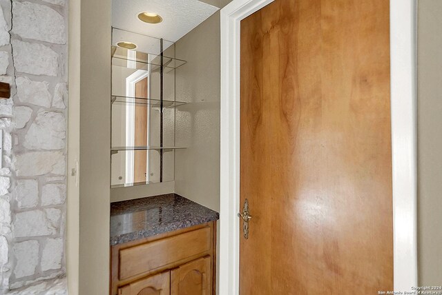 6776 Green Valley Rd, Cibolo, TX 78108 - empty room with a textured ceiling, wood finished floors, and a healthy amount of sunlight