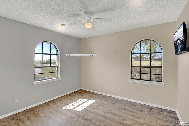 6776 Green Valley Rd, Cibolo, TX 78108 - full bathroom featuring toilet, vanity, a textured ceiling, and plenty of natural light