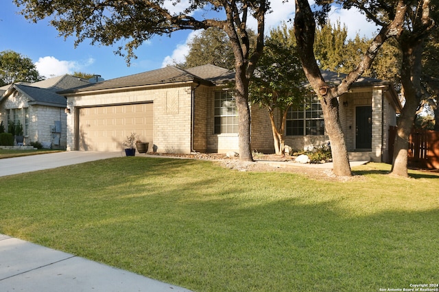 view of front of house featuring a front yard and a garage