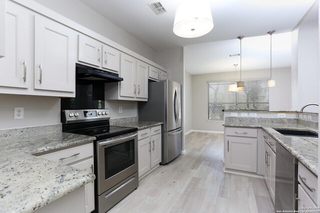 kitchen featuring light hardwood / wood-style flooring, white cabinets, appliances with stainless steel finishes, and sink