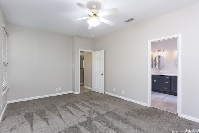 unfurnished bedroom featuring ceiling fan, carpet, and ensuite bath