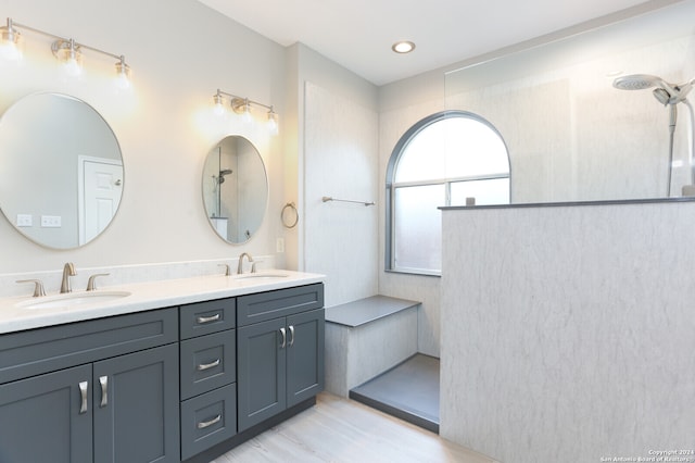 bathroom with vanity, a shower, and hardwood / wood-style floors