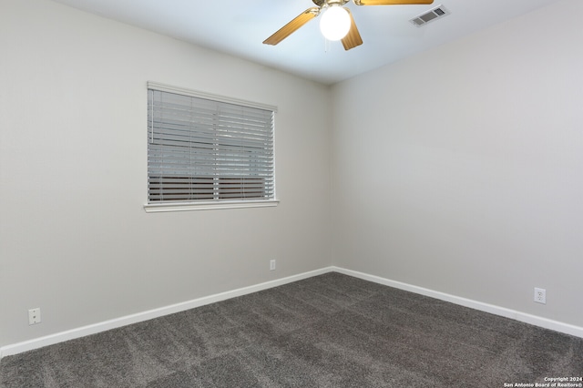 carpeted spare room featuring ceiling fan