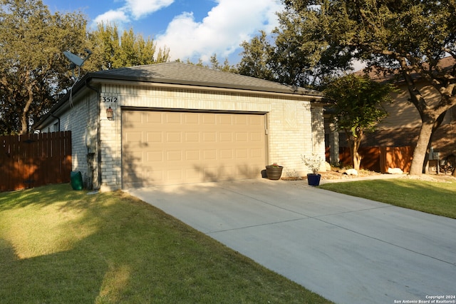 exterior space featuring a garage and a yard