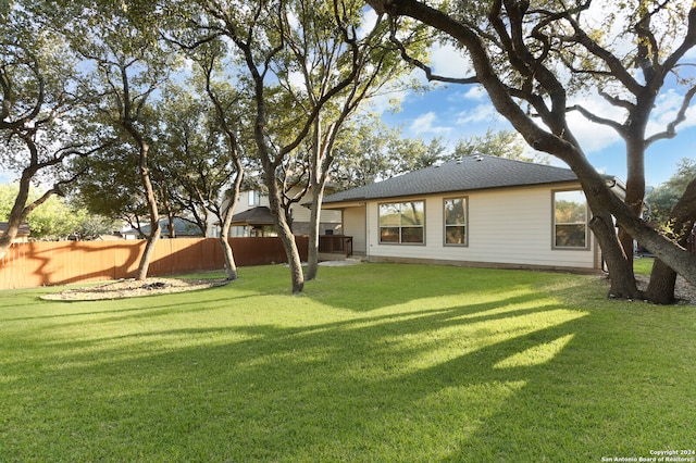 rear view of property with a lawn