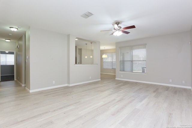 empty room with light hardwood / wood-style flooring and ceiling fan