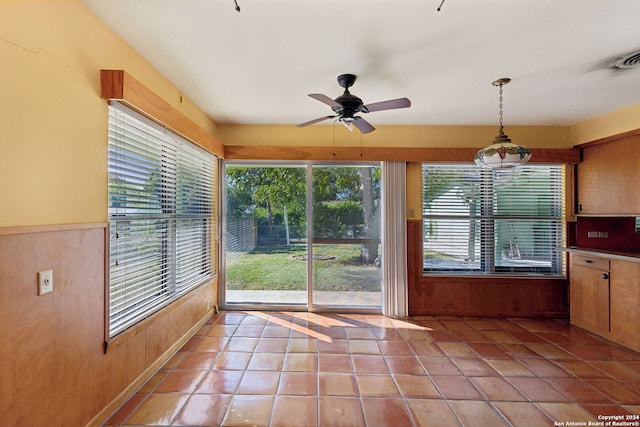 entryway with light tile patterned floors and ceiling fan