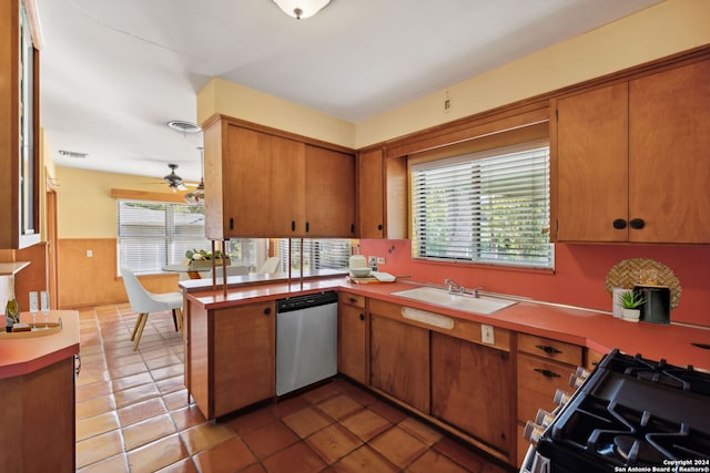 kitchen featuring ceiling fan, range with gas cooktop, sink, kitchen peninsula, and stainless steel dishwasher