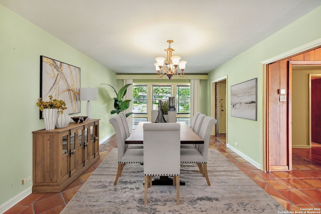 dining space with a chandelier and tile patterned floors