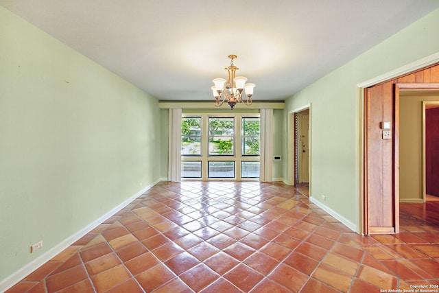 unfurnished room with an inviting chandelier and tile patterned floors