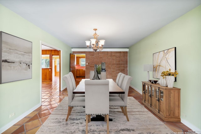 dining area with light tile patterned floors and a chandelier