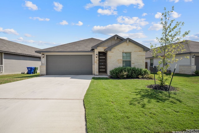 ranch-style home with a front lawn and a garage