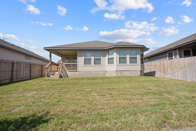 rear view of property with a yard