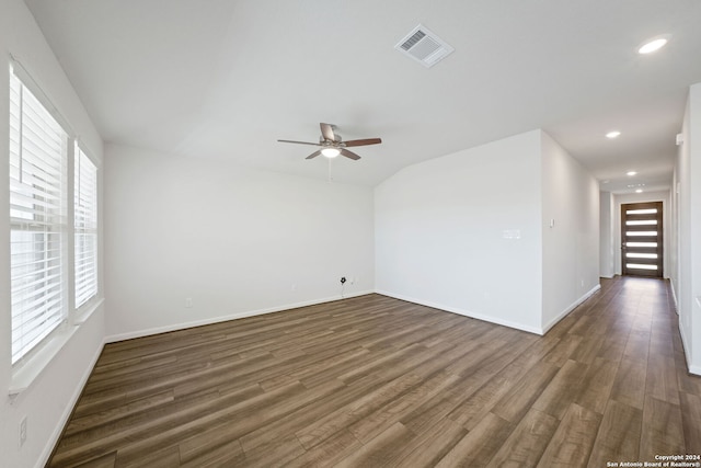 empty room with ceiling fan and dark hardwood / wood-style floors