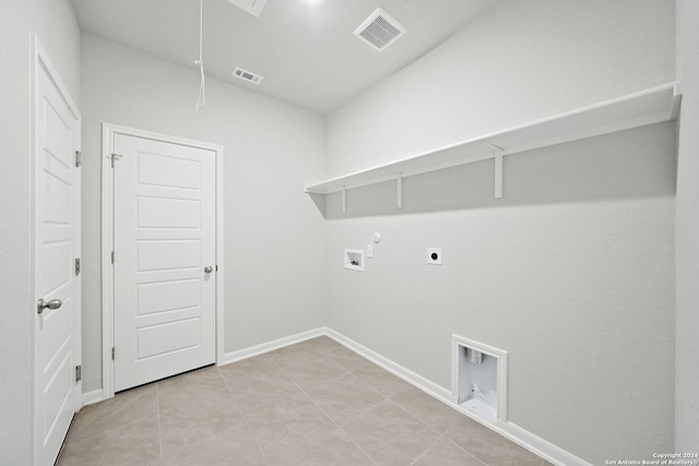 clothes washing area featuring light tile patterned flooring, washer hookup, hookup for a gas dryer, and electric dryer hookup