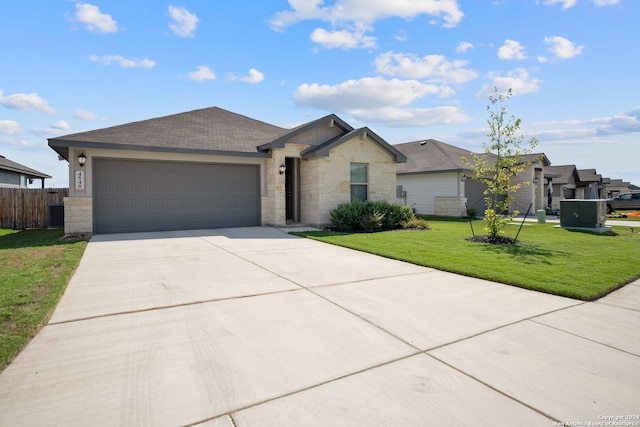 view of front of home featuring a front yard and a garage