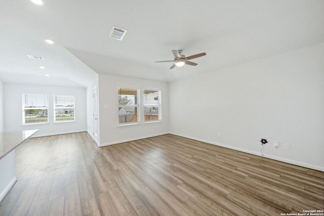 unfurnished living room featuring light hardwood / wood-style floors, a wealth of natural light, and ceiling fan