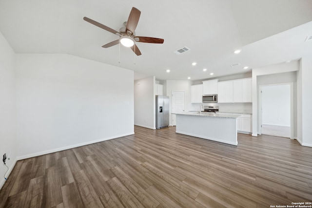 unfurnished living room featuring ceiling fan, lofted ceiling, and hardwood / wood-style floors