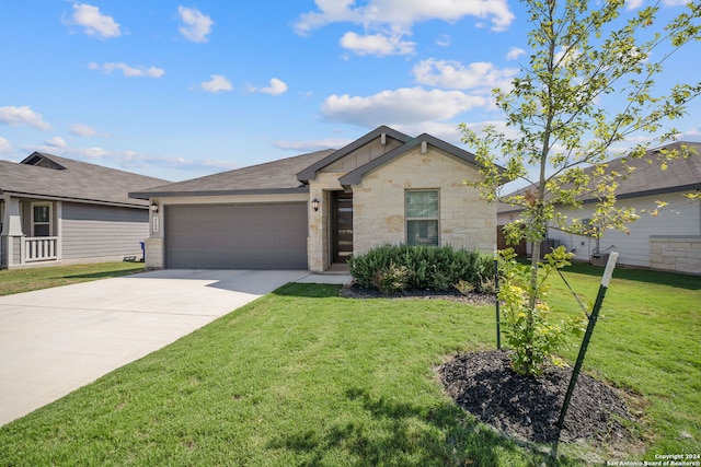 ranch-style house featuring a front yard and a garage