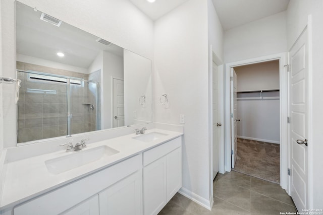 bathroom featuring tile patterned floors, walk in shower, and vanity