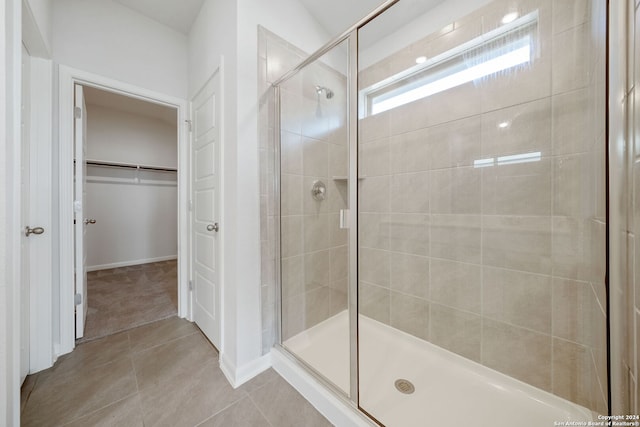 bathroom with walk in shower and tile patterned floors