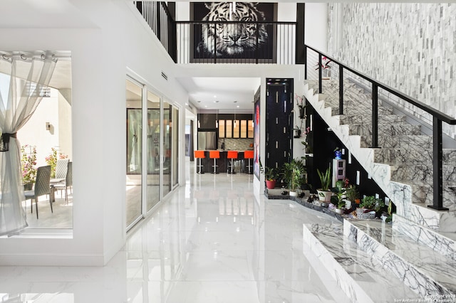 interior space with a notable chandelier and a towering ceiling