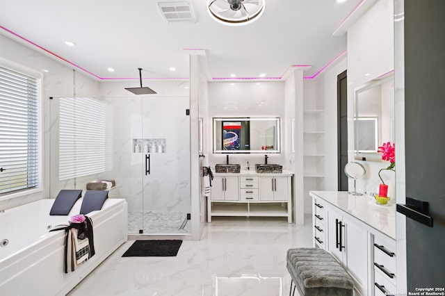 bathroom featuring vanity and separate shower and tub