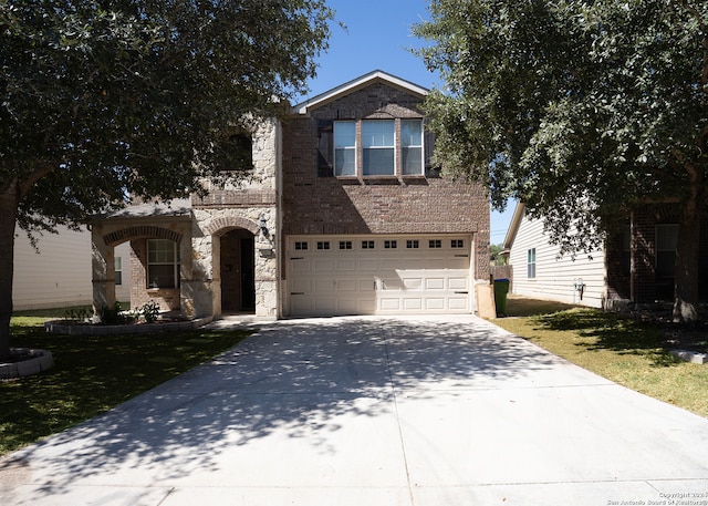 front facade featuring a front lawn and a garage