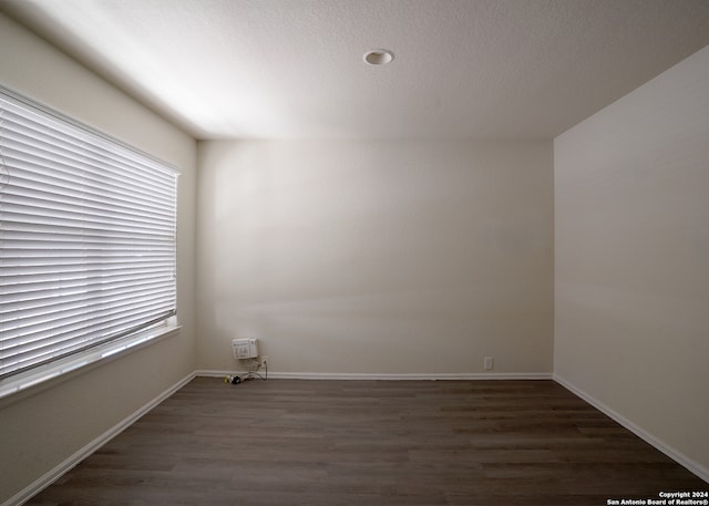 empty room with dark wood-type flooring