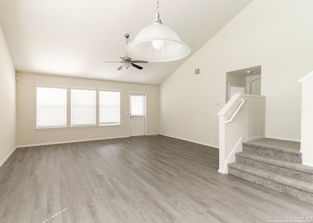 unfurnished living room with wood-type flooring, high vaulted ceiling, and ceiling fan