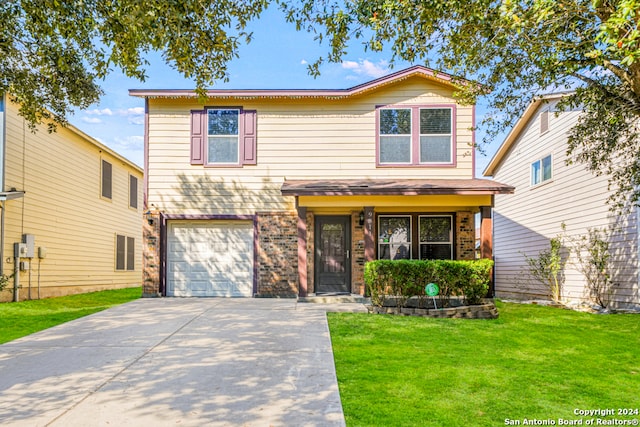 view of front of home with a front yard and a garage