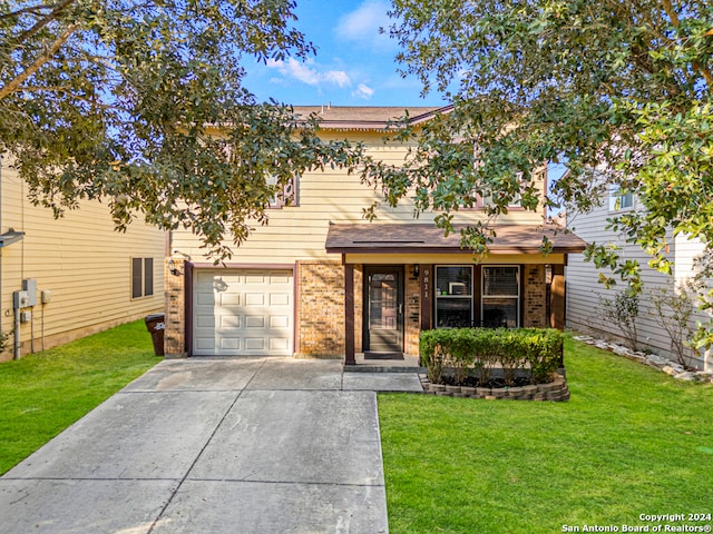 view of front of property with a front yard and a garage