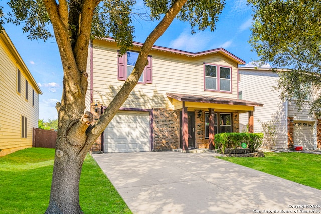 view of front of home with a front yard and a garage