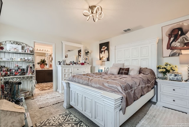 carpeted bedroom with ensuite bath