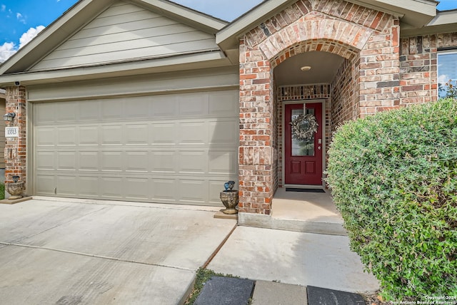 view of exterior entry with a garage