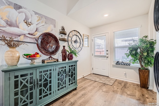 entryway featuring light hardwood / wood-style flooring and lofted ceiling