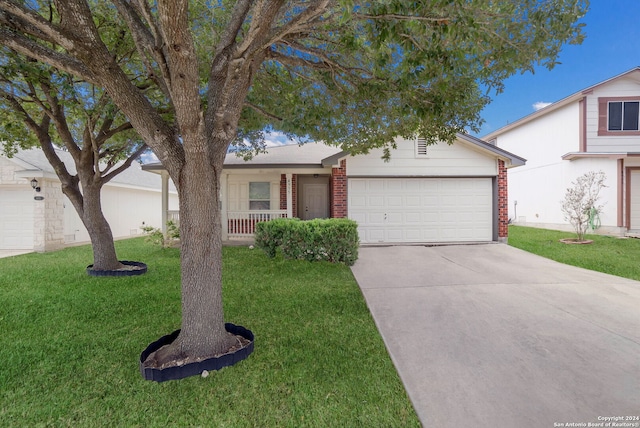 ranch-style home featuring a front lawn, covered porch, and a garage