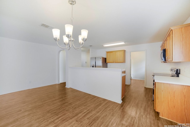 kitchen featuring light brown cabinets, a notable chandelier, hanging light fixtures, light hardwood / wood-style flooring, and appliances with stainless steel finishes