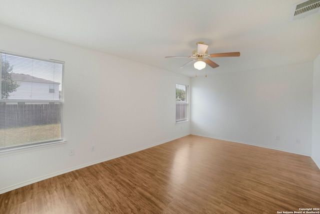 unfurnished room with ceiling fan and hardwood / wood-style floors