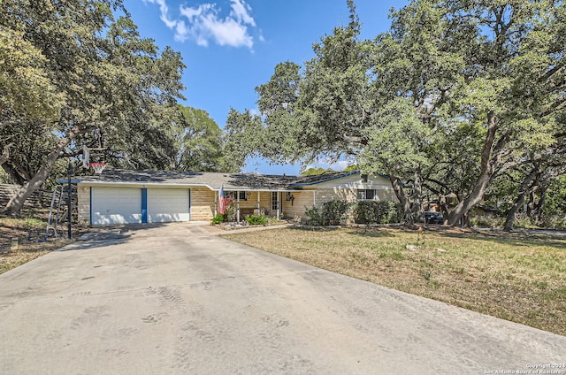 ranch-style house with a garage and a front yard