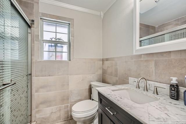 bathroom featuring an enclosed shower, tile walls, vanity, and toilet