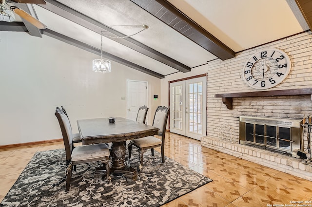 dining space with lofted ceiling with beams, french doors, light tile patterned flooring, a fireplace, and a textured ceiling