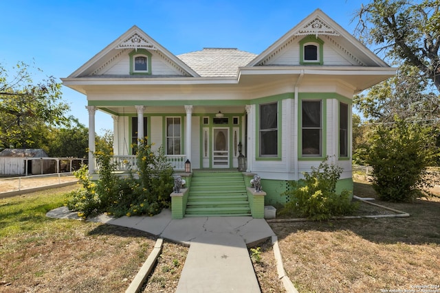 view of front of home with a porch and a front lawn