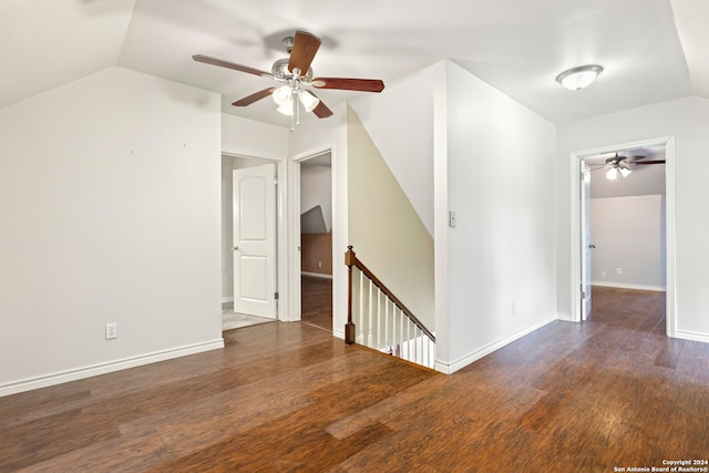 unfurnished room with ceiling fan, vaulted ceiling, and dark hardwood / wood-style floors