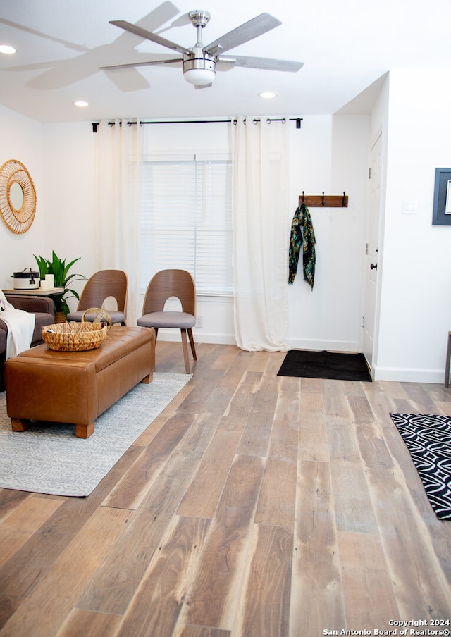 interior space featuring wood-type flooring and ceiling fan