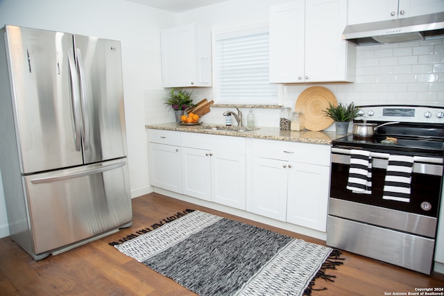 kitchen featuring white cabinets, sink, dark wood-type flooring, appliances with stainless steel finishes, and decorative backsplash