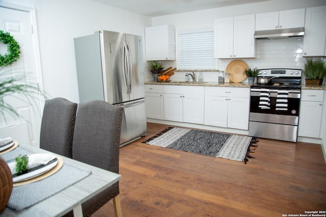 kitchen featuring light stone countertops, decorative backsplash, dark hardwood / wood-style floors, white cabinetry, and appliances with stainless steel finishes